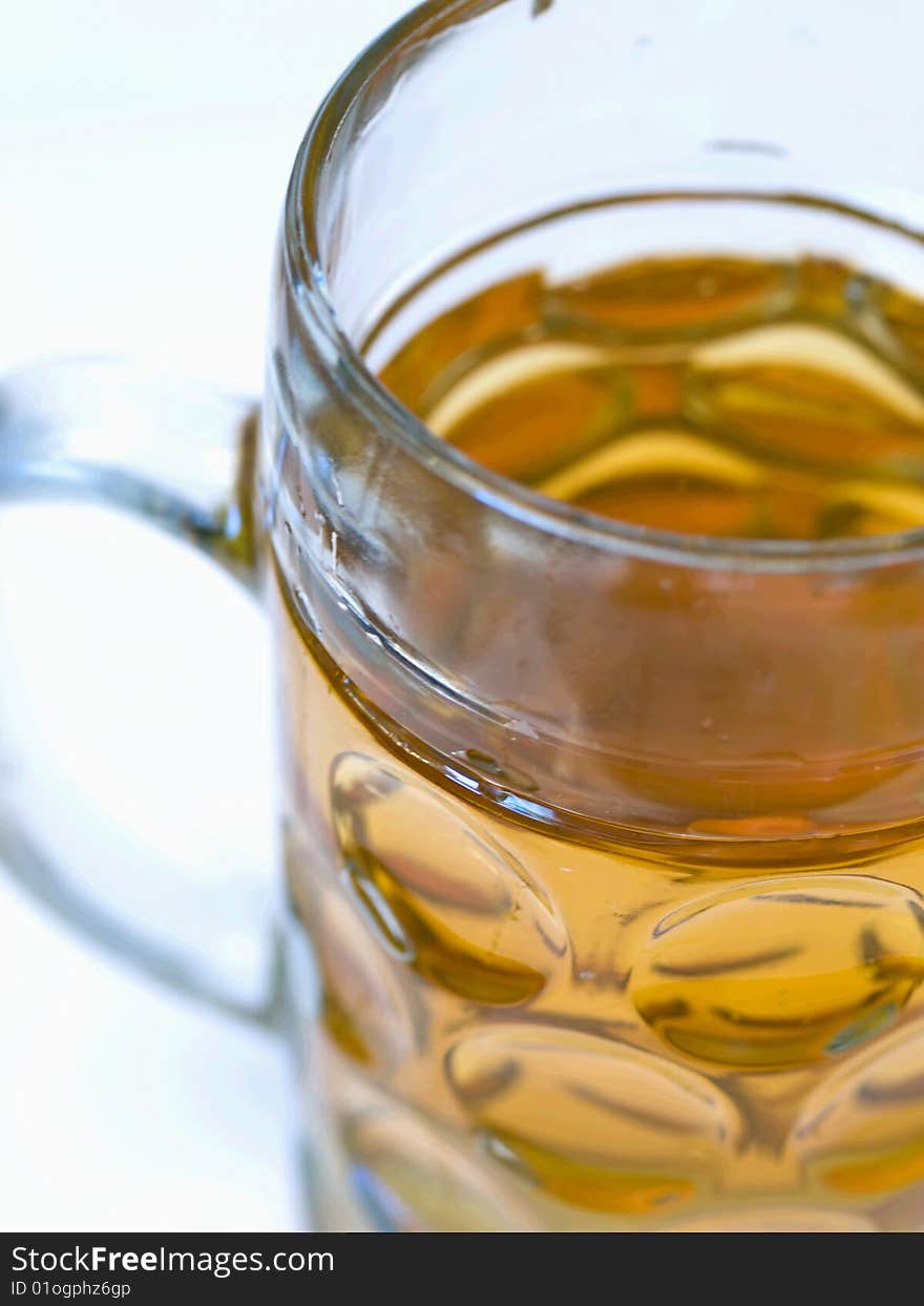 Close-up of a light beer in a big beer glass without foam. Close-up of a light beer in a big beer glass without foam