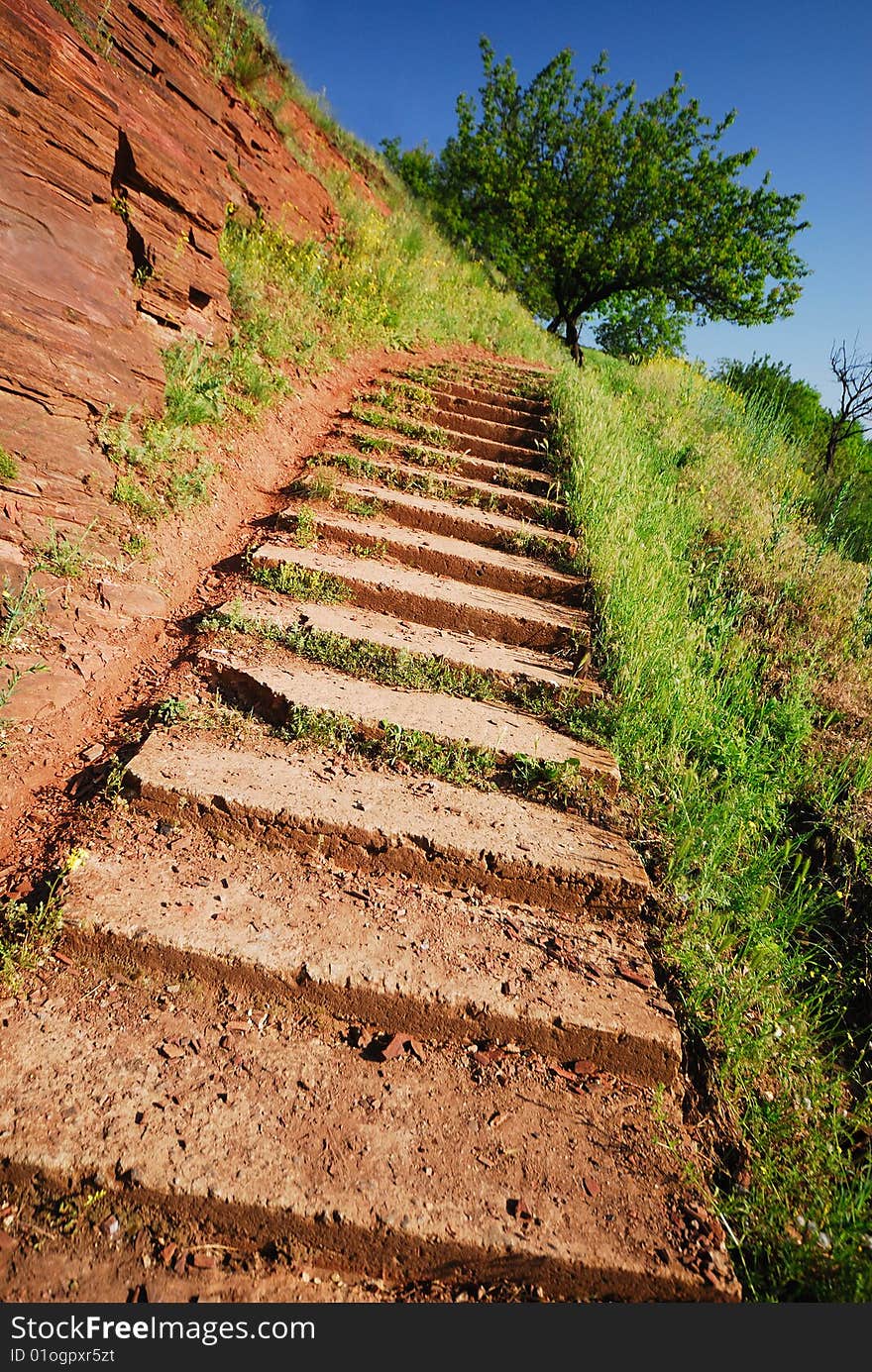 Concrete steps for pedestrians in hilly district,  green tree and  blue sky