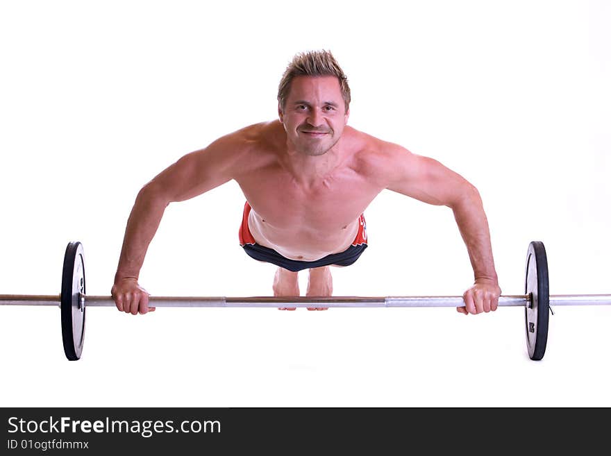 Man making pushups on barbell. Man making pushups on barbell