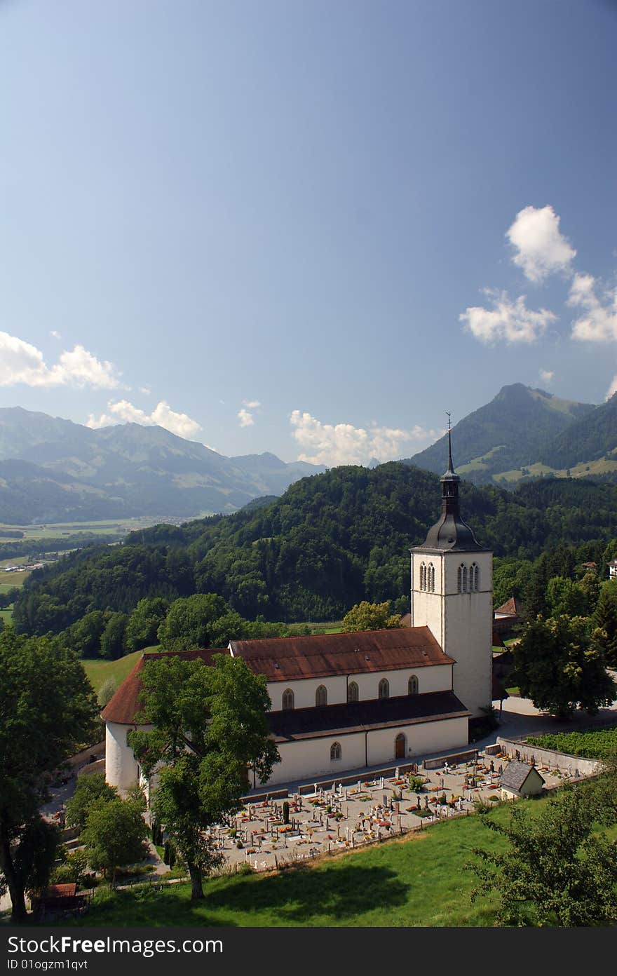 Church in Gruyere, Switzerland in summer under a blue sky. Church in Gruyere, Switzerland in summer under a blue sky.