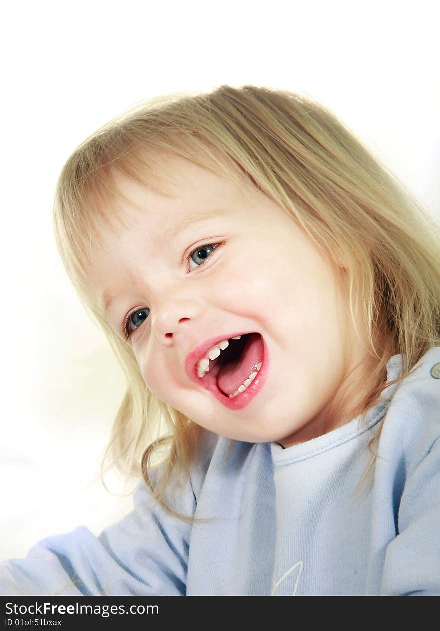 Smiling toddler girl over white portrait