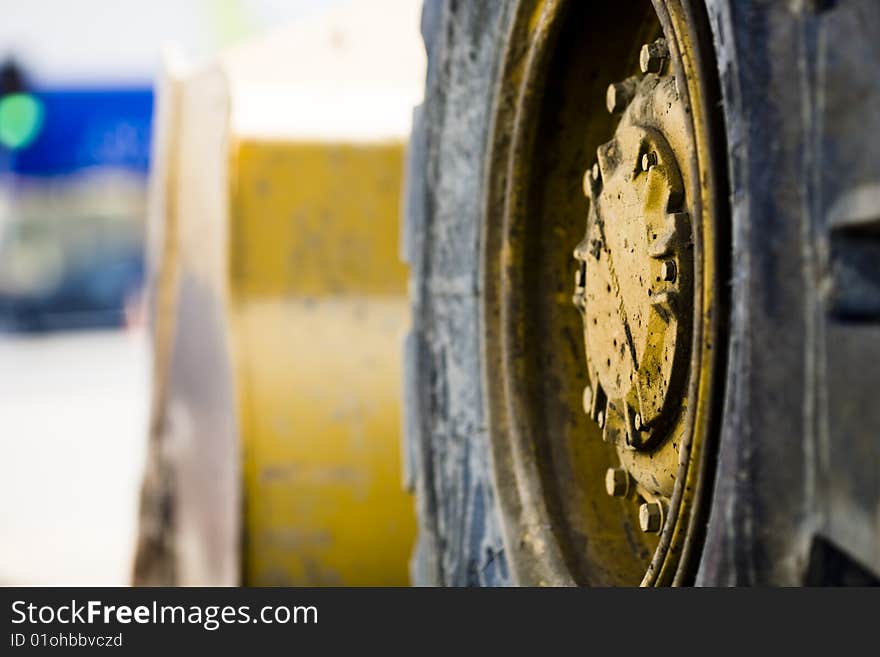 Closeup photo of roadwork machinery. Selective focus on wheel. Closeup photo of roadwork machinery. Selective focus on wheel.