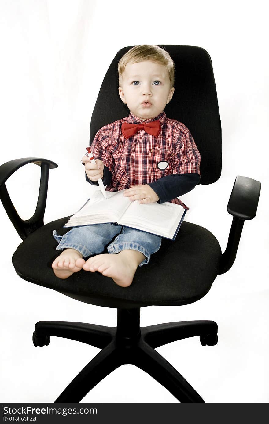 Little boy smiling sitting in the armchair. Little boy smiling sitting in the armchair