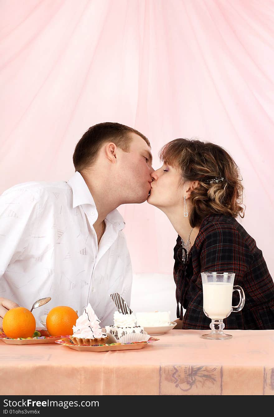 Young couple in love feeding each other with cake