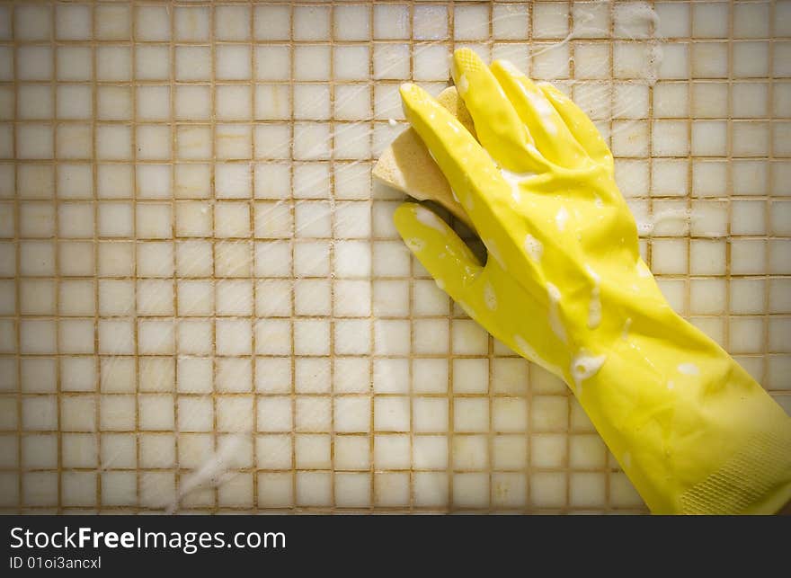 Hand in rubber glove washing the wall. Hand in rubber glove washing the wall