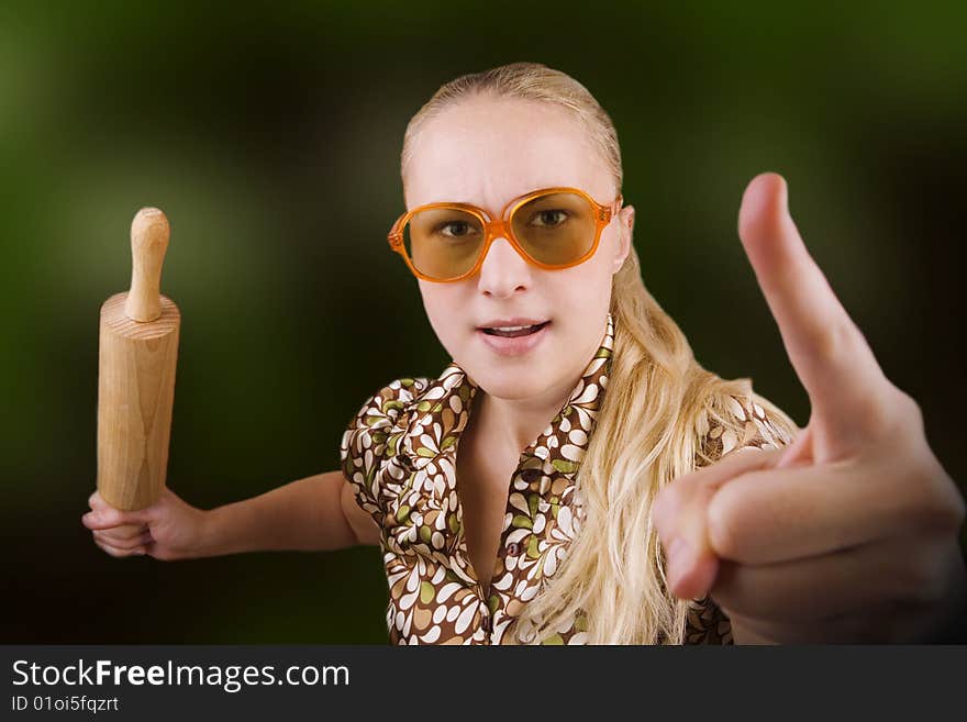 Woman with kitchen tool (rolling pin) - as angry wife