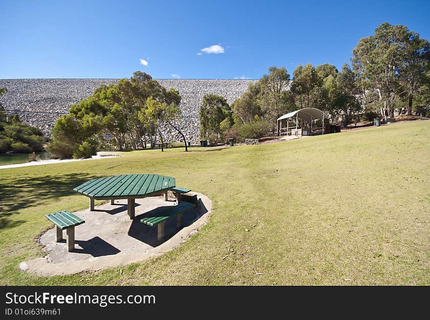 A widespread picnic area in a park, complete with barbeque facilities and a huge grass patch for children to run about and play. A widespread picnic area in a park, complete with barbeque facilities and a huge grass patch for children to run about and play.