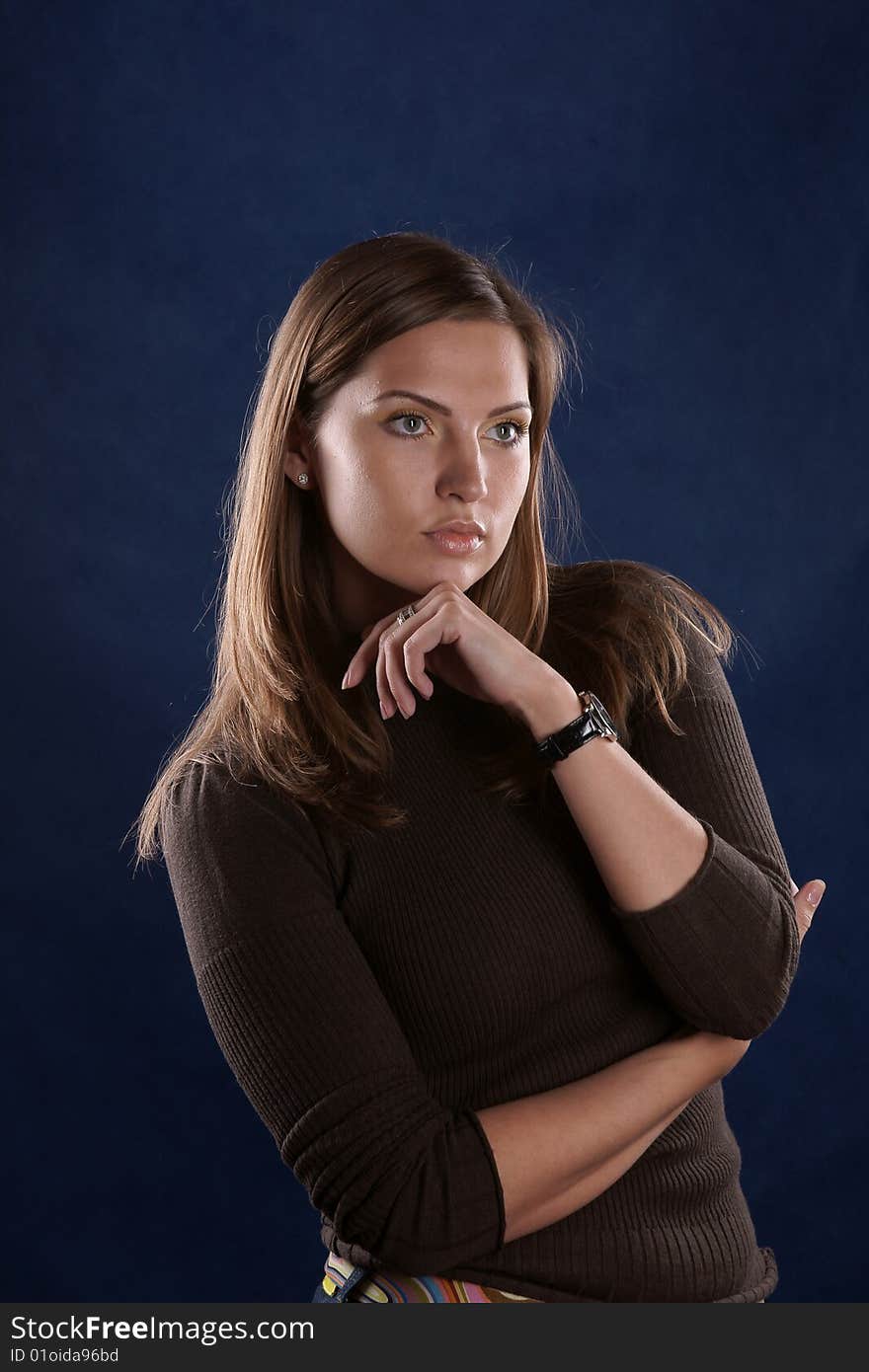 The portrait of the beautiful girl is photographed on a dark blue background