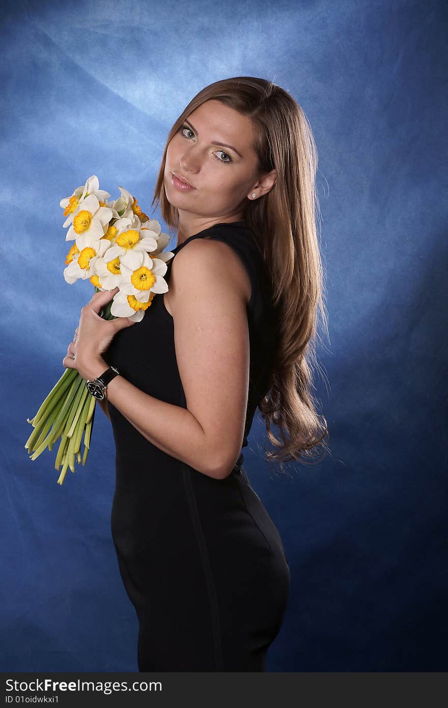 The girl with colours is photographed on a dark blue background