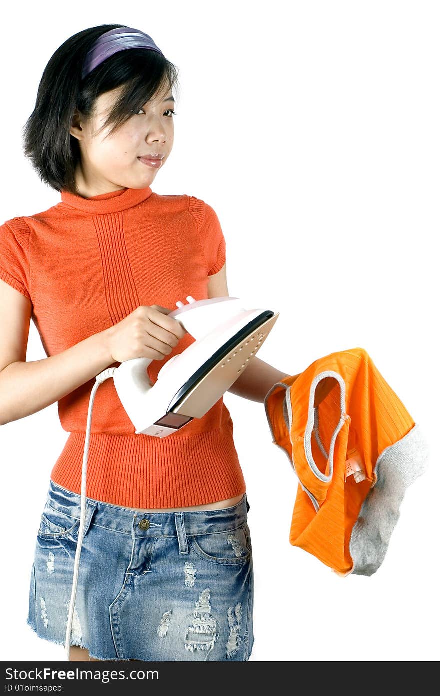 Charming, Asian girl holding iron. Young housewife ironing her clothes. Charming, Asian girl holding iron. Young housewife ironing her clothes.