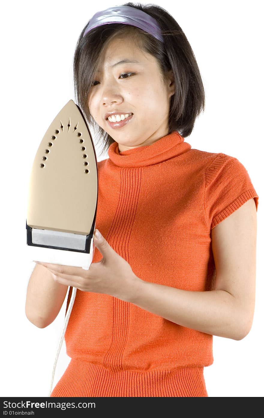 Charming, Asian girl holding iron. Young housewife ironing her clothes. Charming, Asian girl holding iron. Young housewife ironing her clothes.