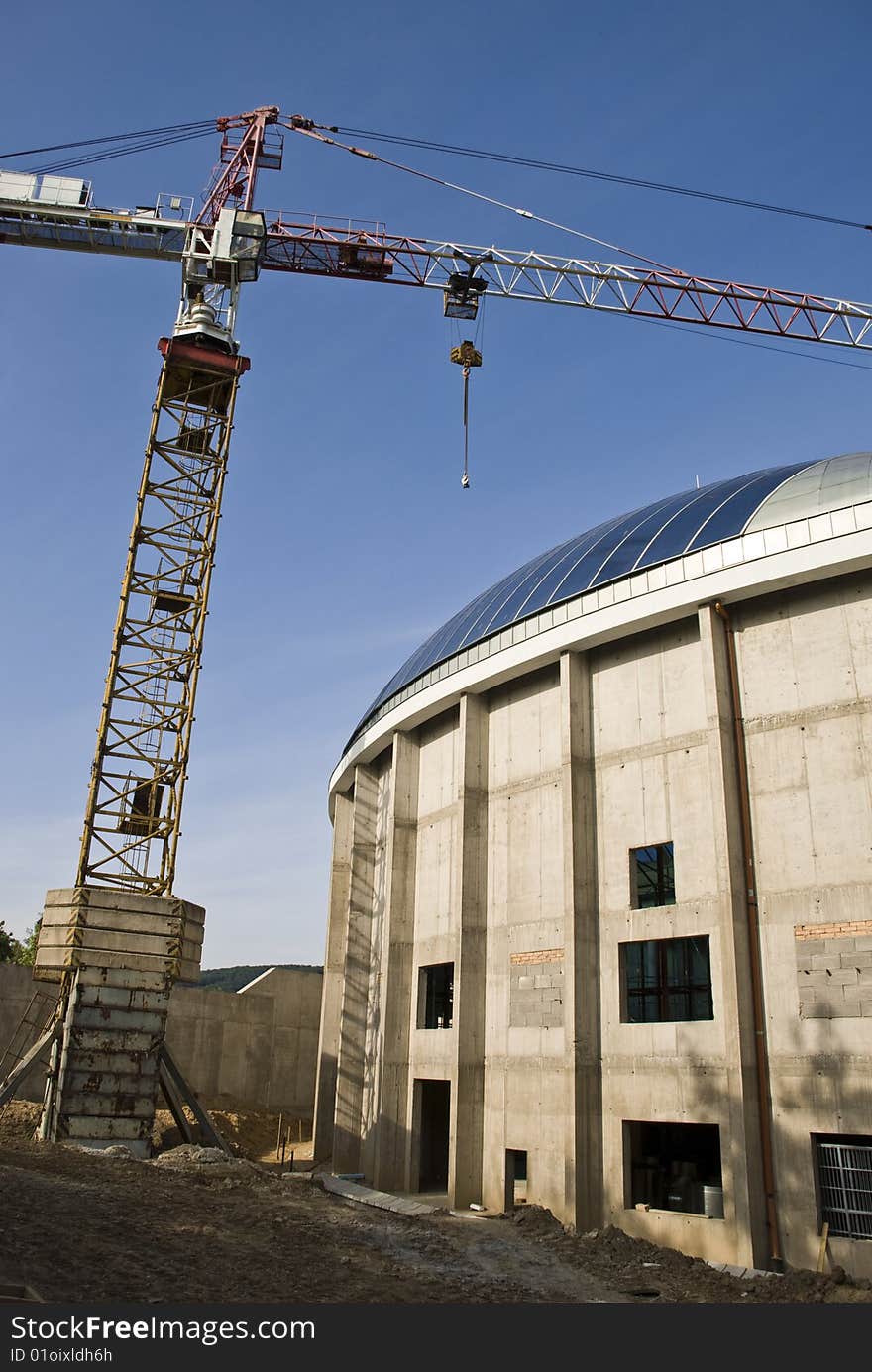 A construction of a new office building with a crane. A construction of a new office building with a crane.