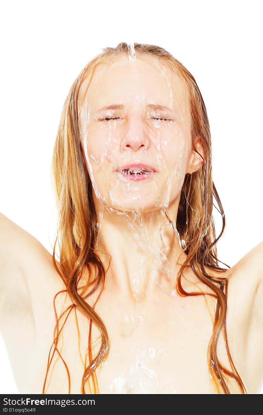 Water drops on the face of the young beautiful woman