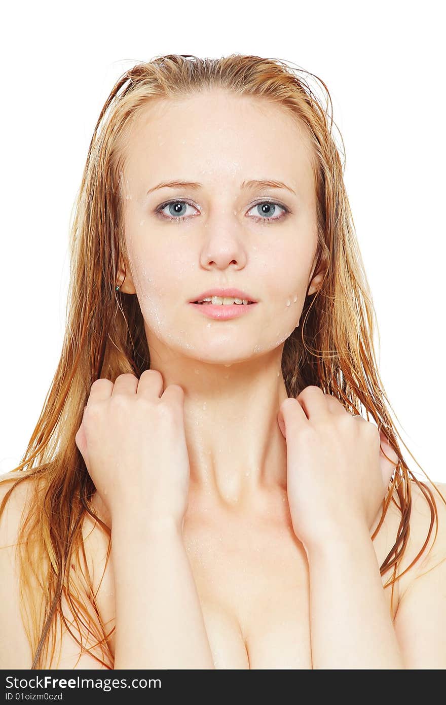 Water drops on the face of the young beautiful woman