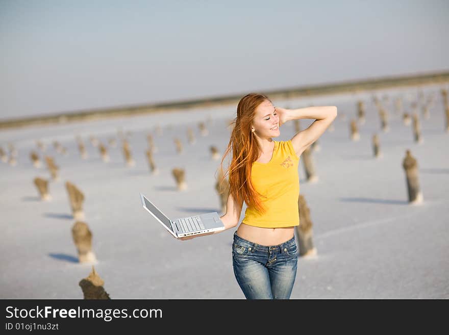 Happy girl with notebook on the sand