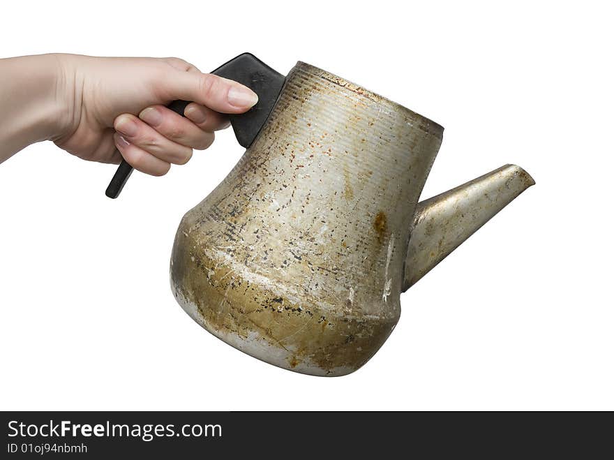 Woman hand holding old dirty rusty kettle isolated on white background. Woman hand holding old dirty rusty kettle isolated on white background