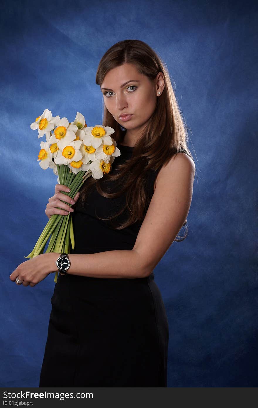 The girl with colours is photographed on a dark blue background