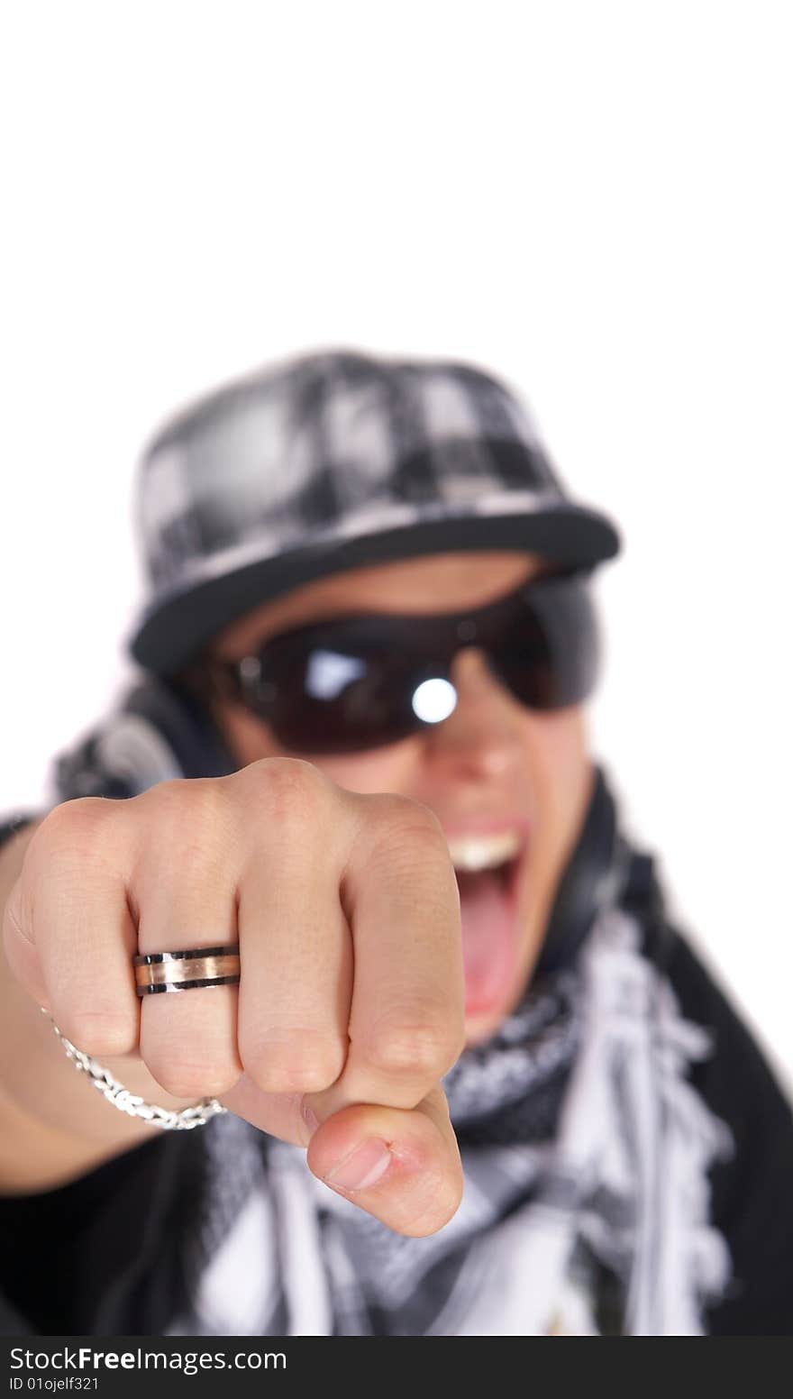 A young DJ is pointing at the camera and screaming. The focus is on his fist! Isolated over white. A young DJ is pointing at the camera and screaming. The focus is on his fist! Isolated over white.