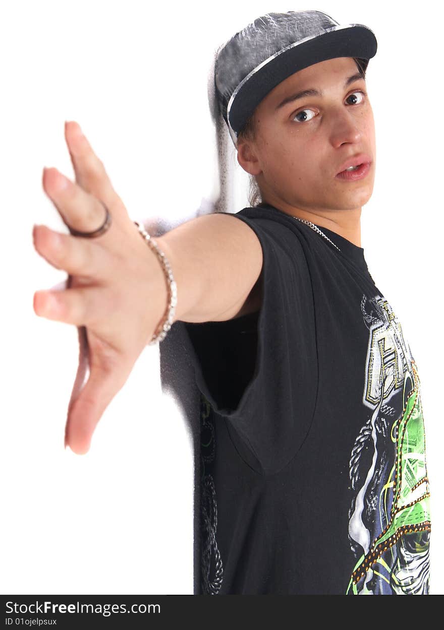 Young gangster leaning against a wall isolated over white. Young gangster leaning against a wall isolated over white.