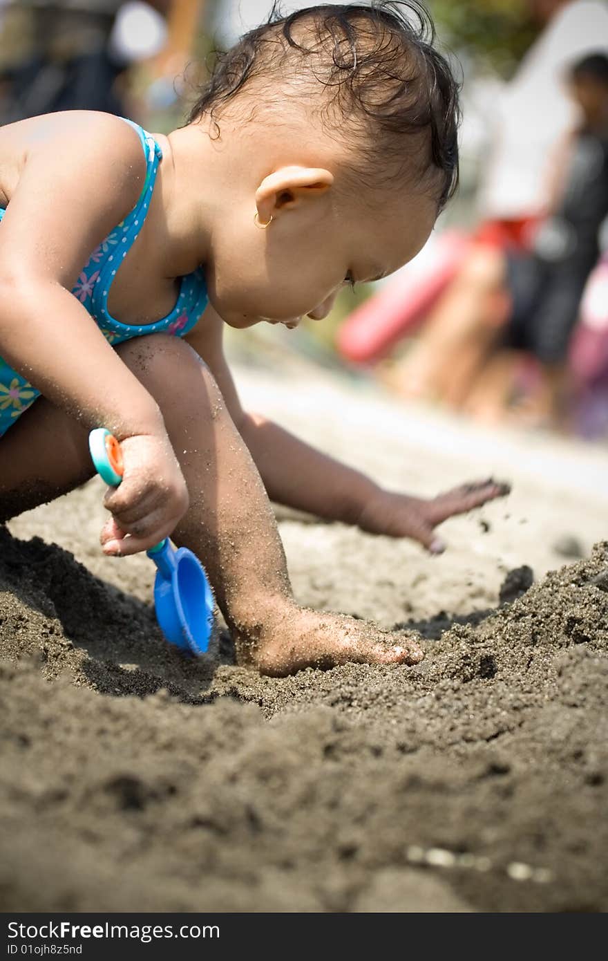 Baby Playing At The Beach