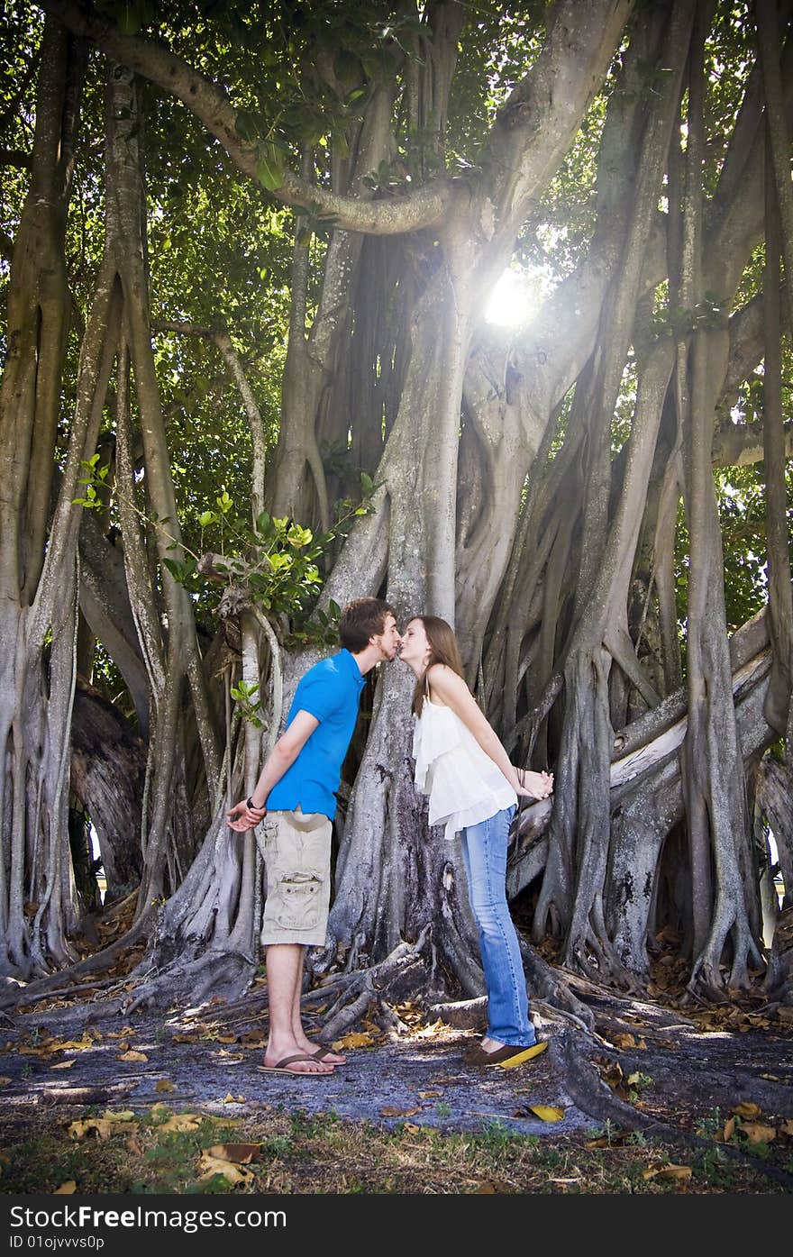 Couple kissing under tree