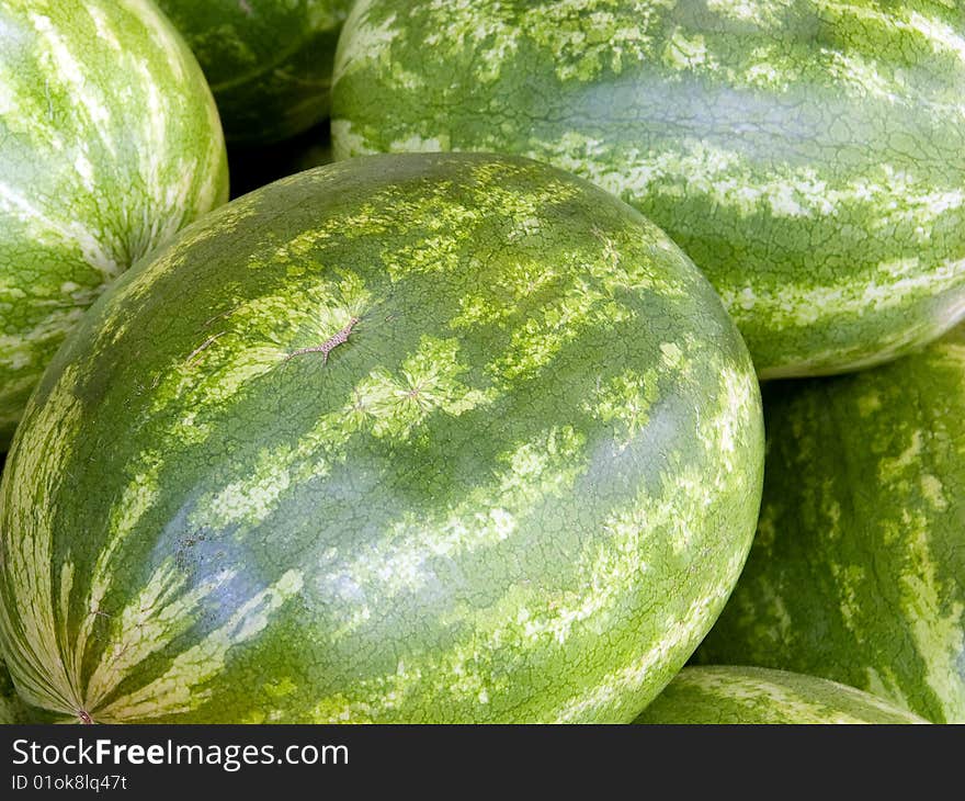 Close up on some watermelons on a market's table.