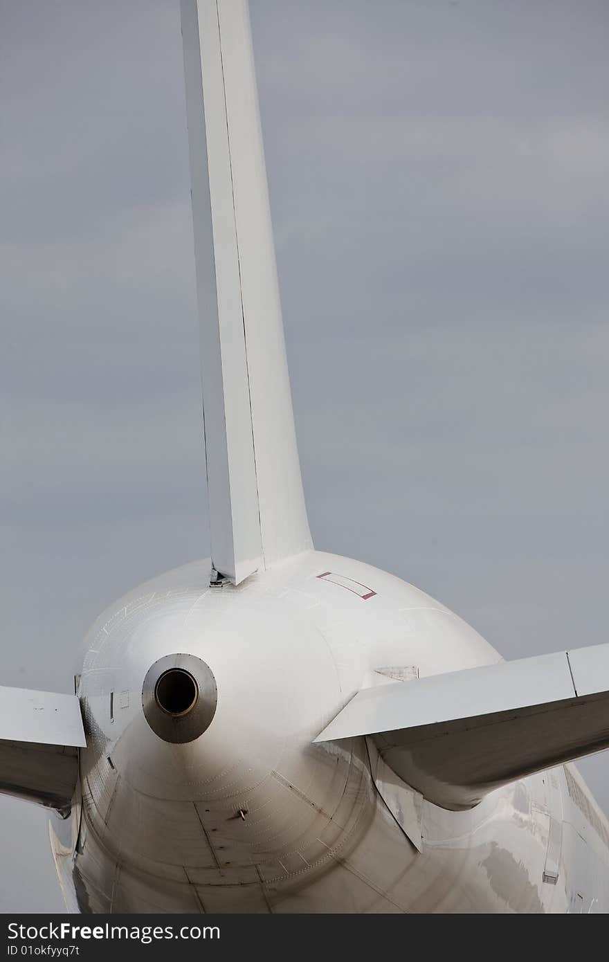 Back of a white  airplane  vertical with copy space