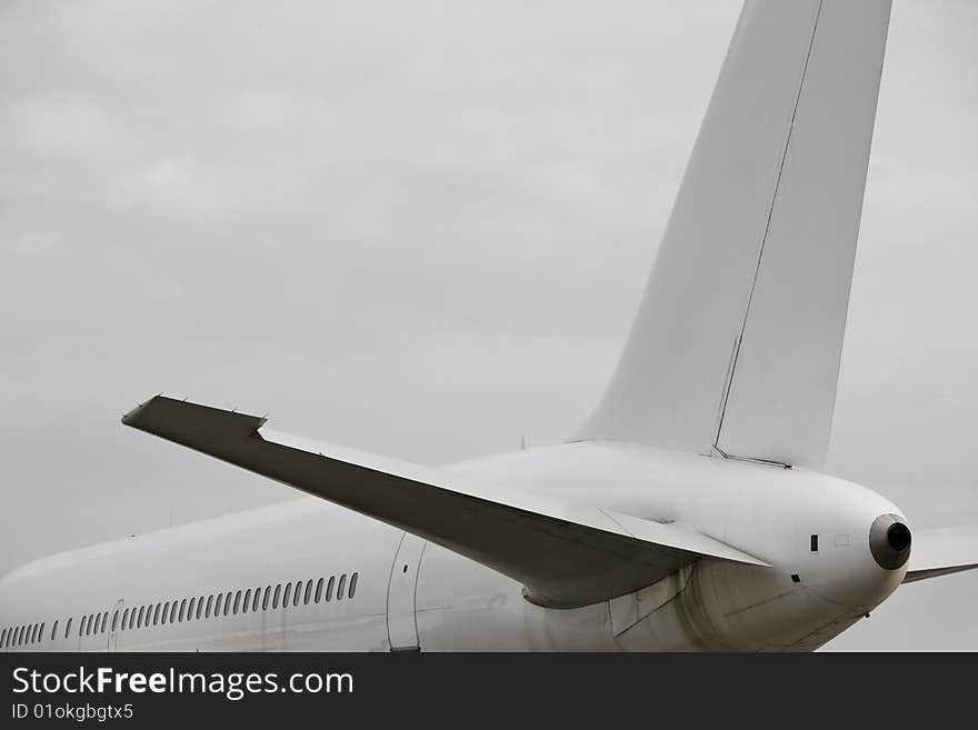 White airplane against white sky with copy room. White airplane against white sky with copy room