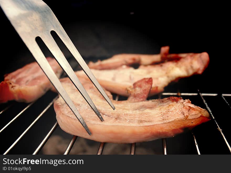 Detail of chop of pork in a barbecue. Detail of chop of pork in a barbecue