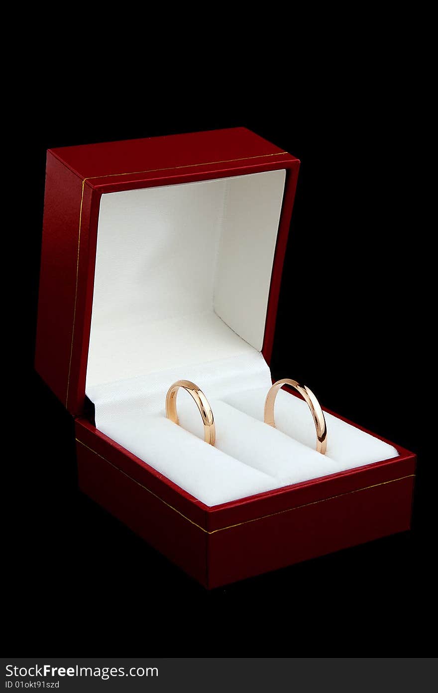 Wedding rings in a red box  on a black background