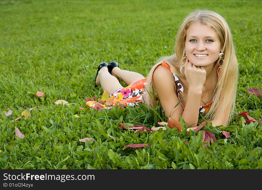 Young woman lying on a green grass