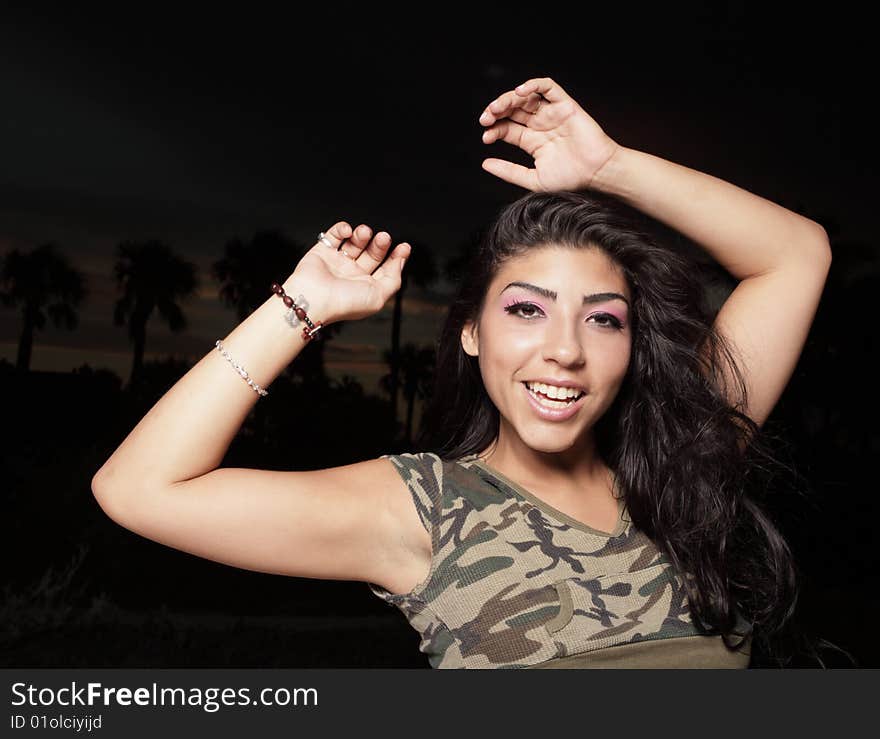 Woman smiling with her arms above her head