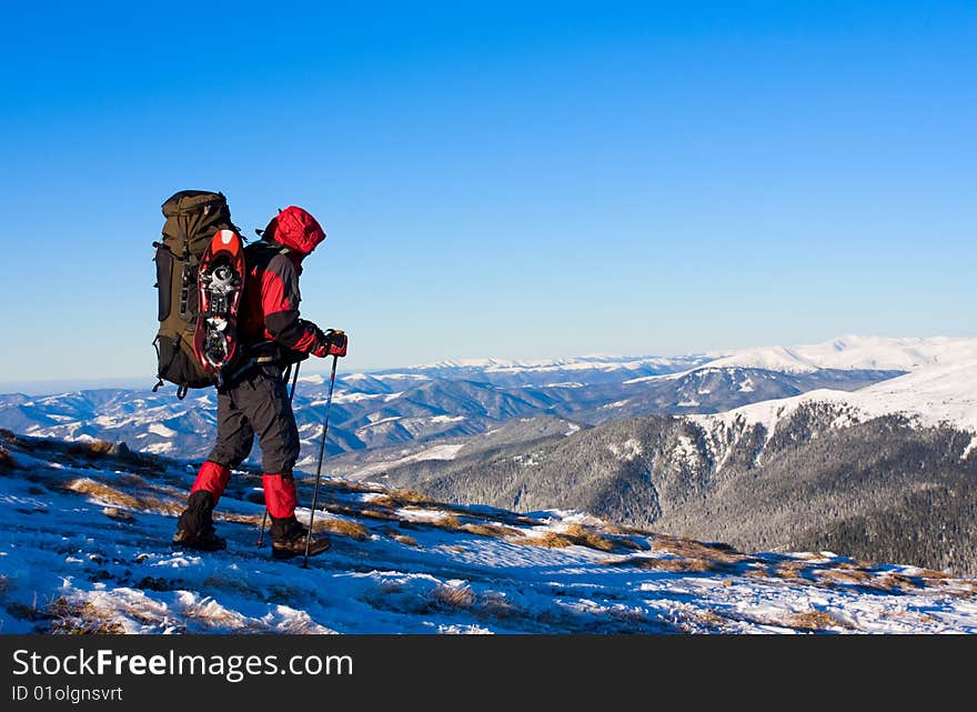 Hikers are in winter in mountains