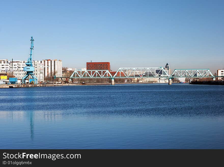 Blue river with railroad bridge city landscape. Blue river with railroad bridge city landscape