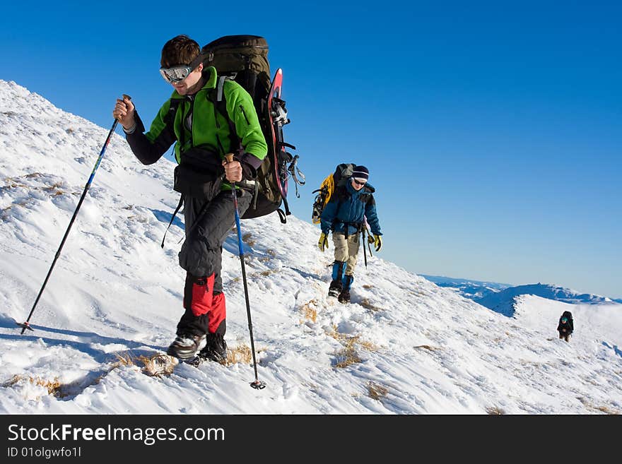 Hikers are in winter in mountains