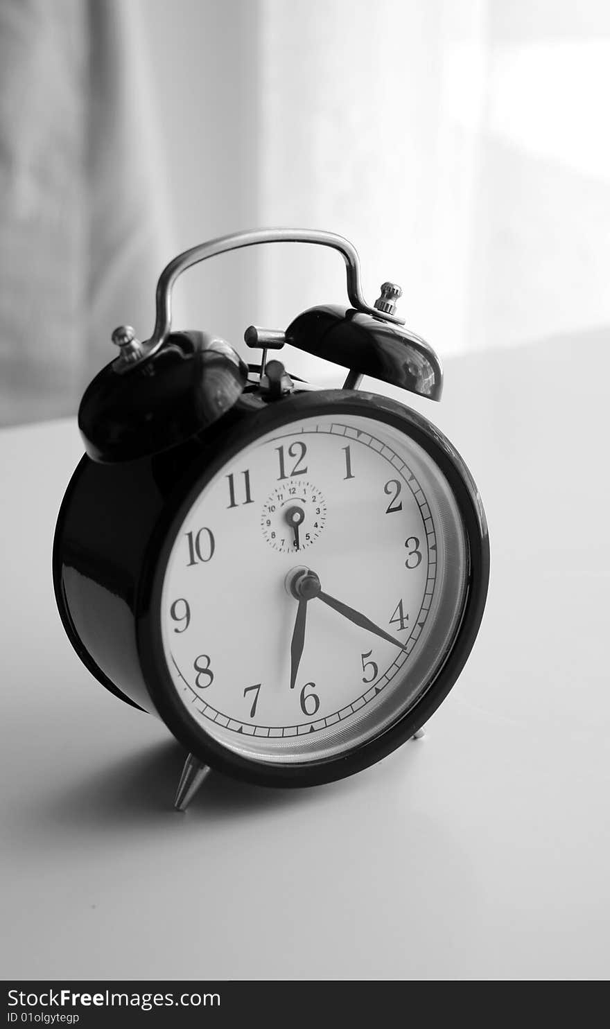 An alarm clock shot in black and white. An alarm clock shot in black and white