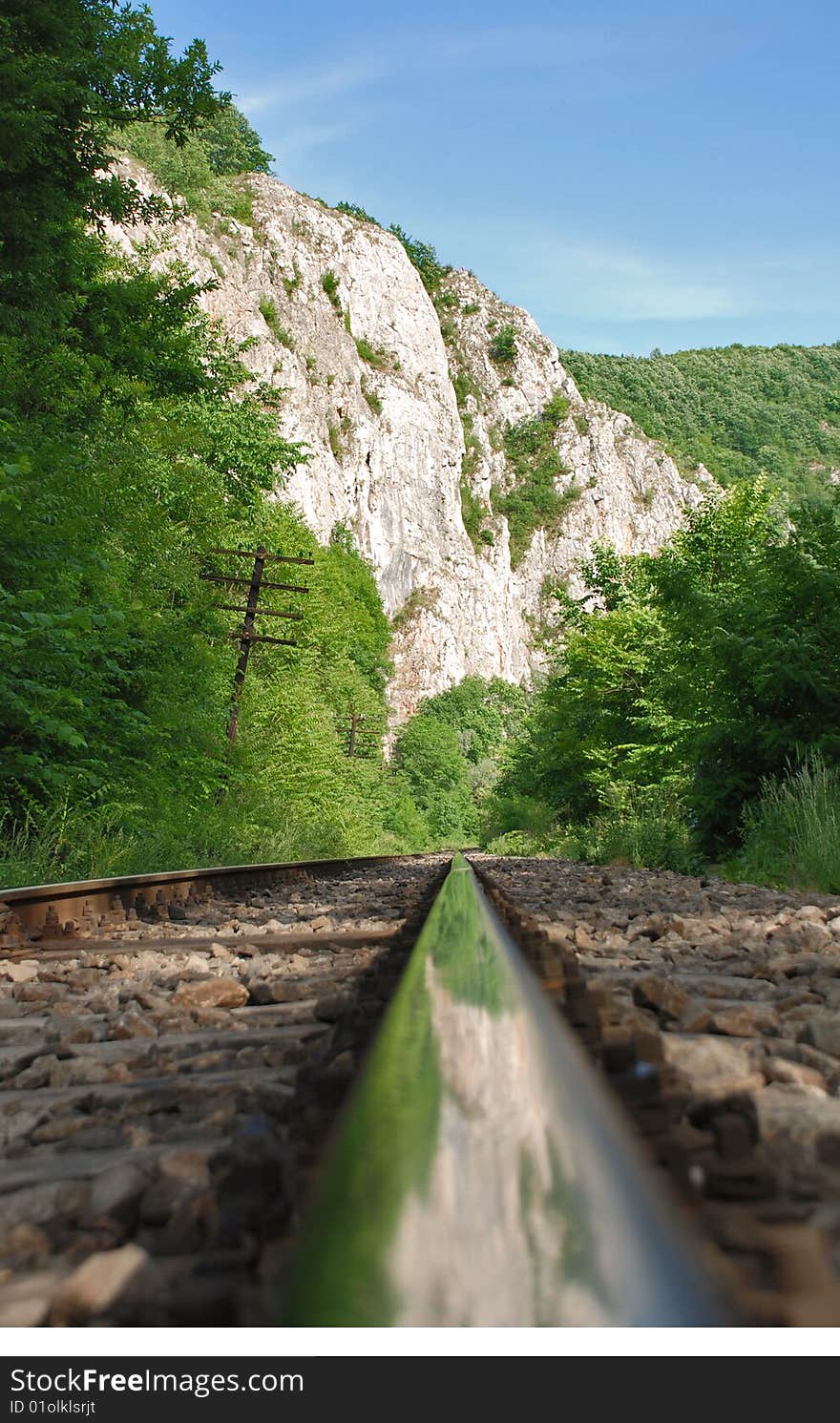 Landscape with  railway in the mountains- mountain and sky reflected in the  railway track