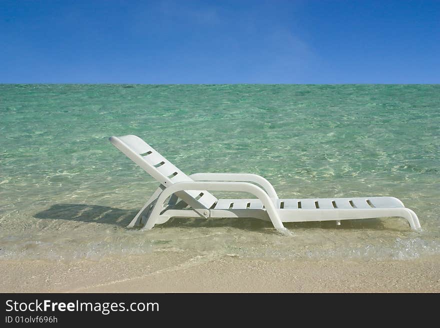 A white plastic chair photographed at the sea. A white plastic chair photographed at the sea.