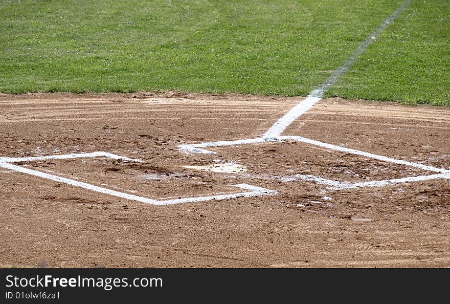 A closeup view of home plate on a baseball field