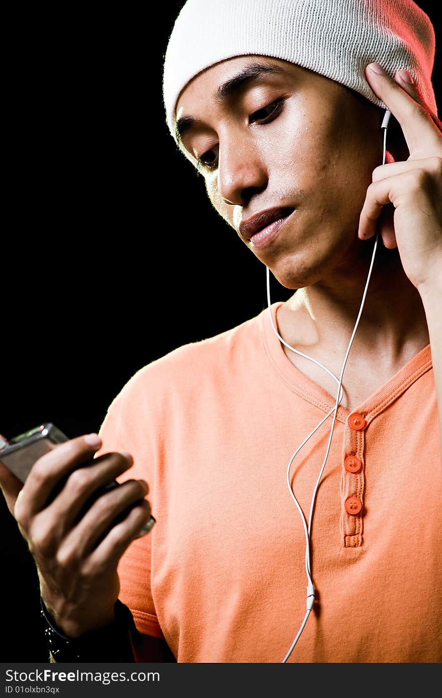 A handsome asian male listening to music