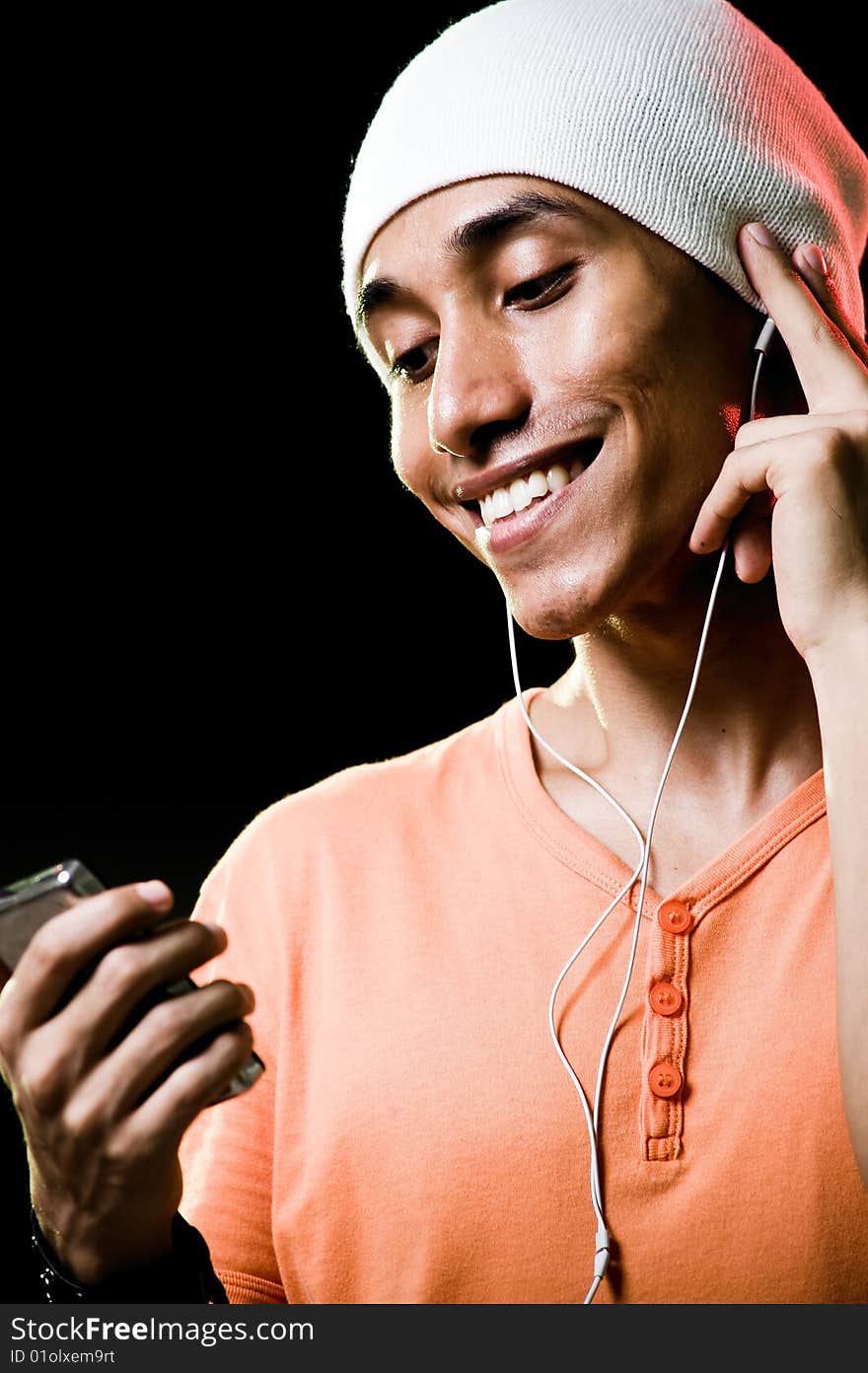 A handsome asian male listening to music