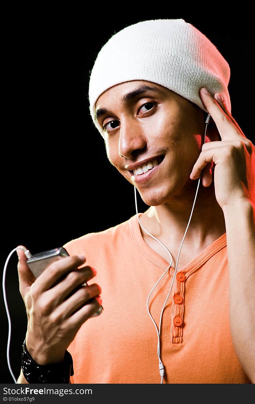 A handsome asian male listening to music