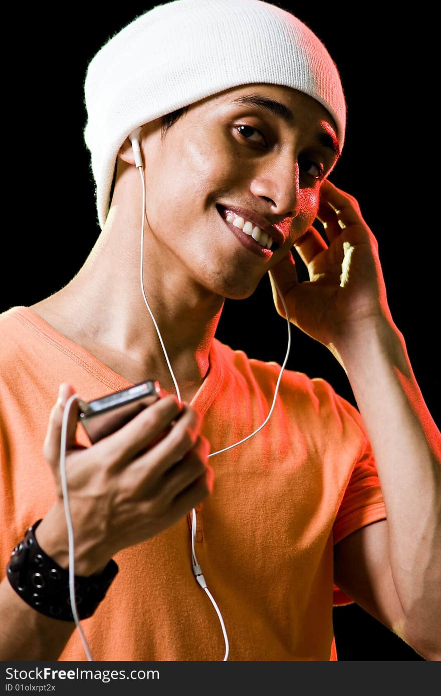 A handsome asian male listening to music