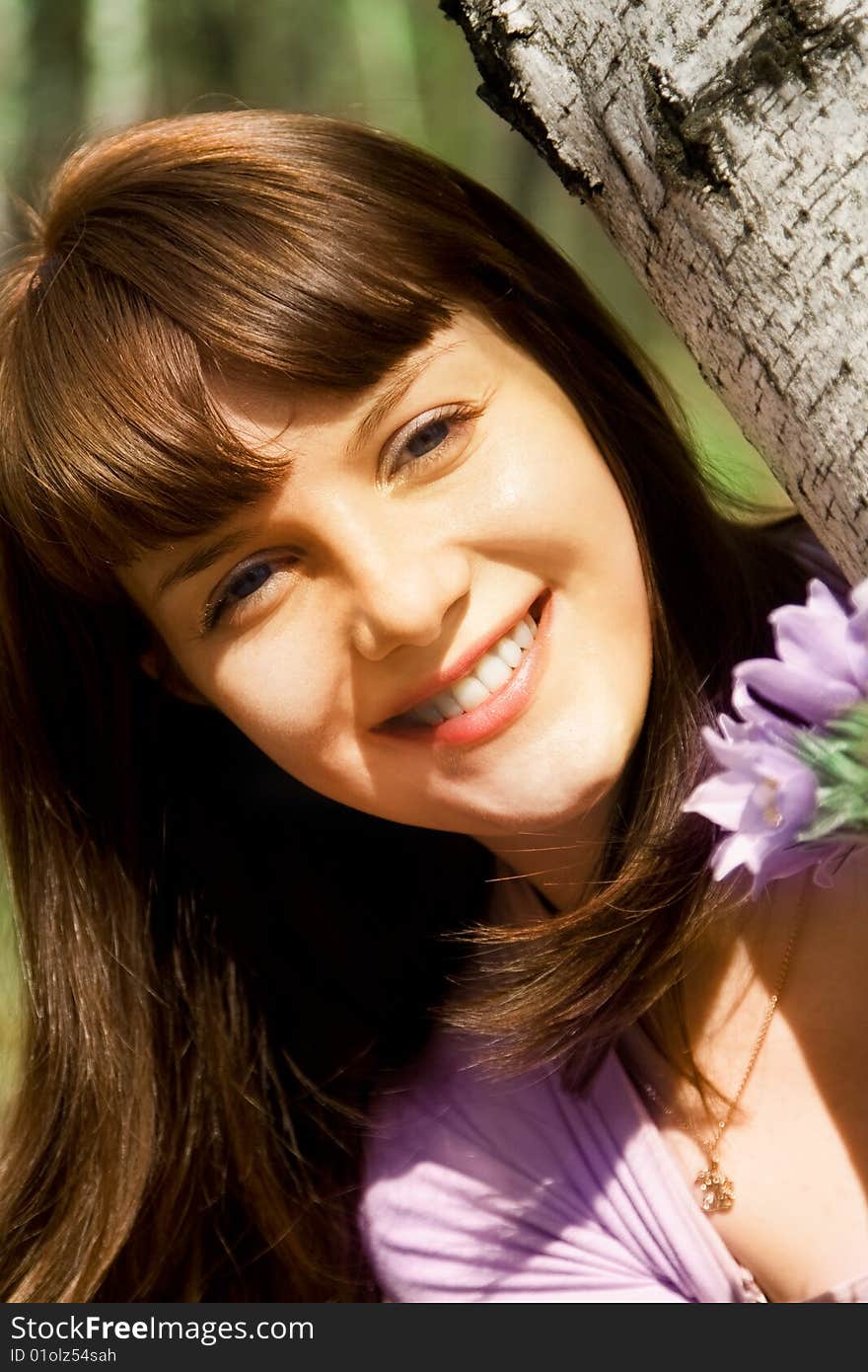 Young adult woman in a birch wood with snowdrops. Young adult woman in a birch wood with snowdrops