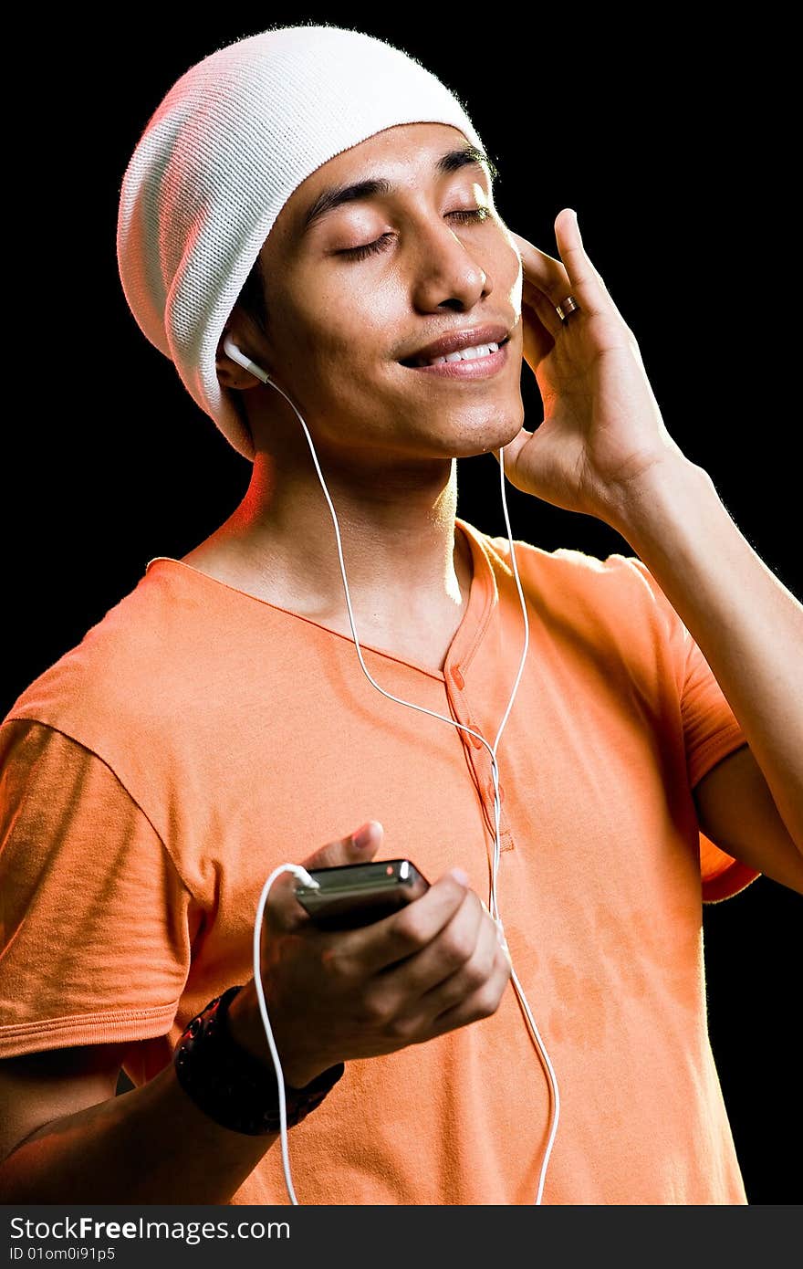 A handsome asian male listening to music