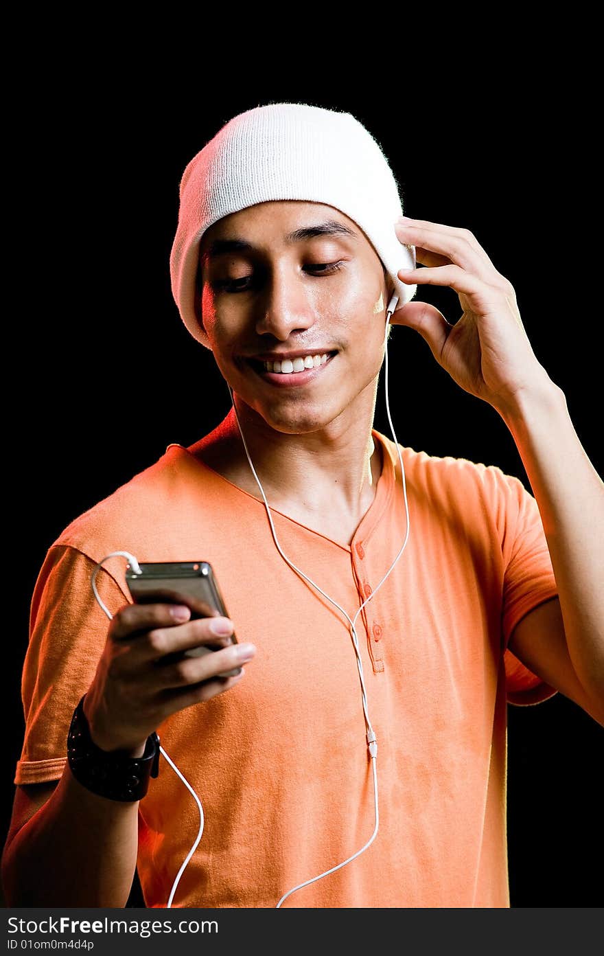 A handsome asian male listening to music