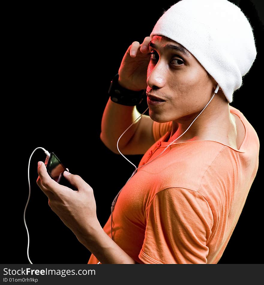 A handsome asian male listening to music