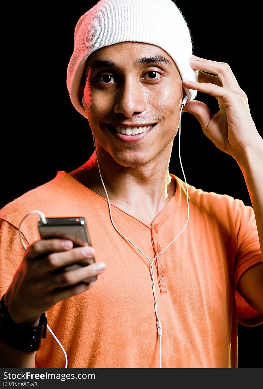 A handsome asian male listening to music