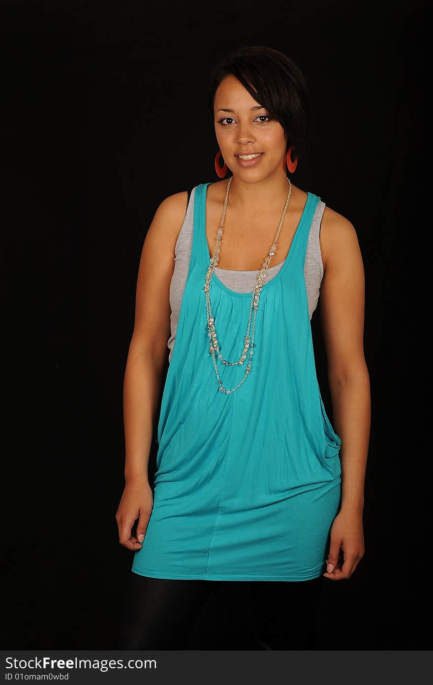 A closeup portrait of a pretty African American teenage woman.  Black background. A closeup portrait of a pretty African American teenage woman.  Black background