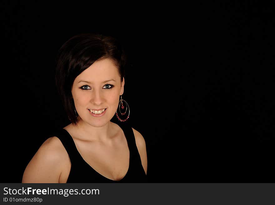 A formal portrait of a dark haired teenage girl.  Black background. A formal portrait of a dark haired teenage girl.  Black background